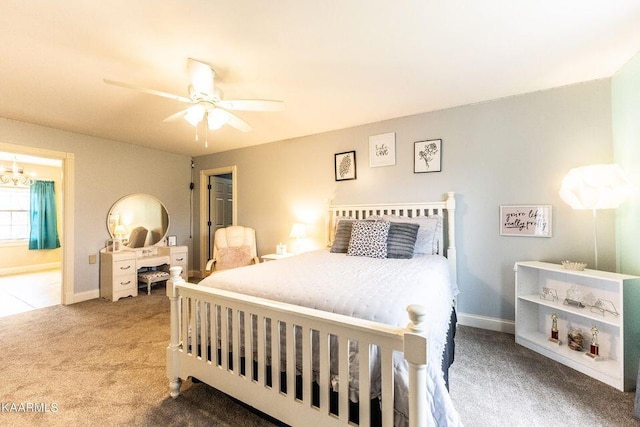 bedroom with baseboards, carpet floors, connected bathroom, and ceiling fan with notable chandelier