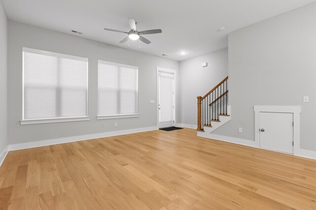 unfurnished living room featuring light wood-type flooring and ceiling fan