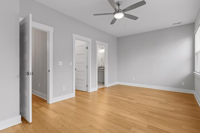 unfurnished bedroom featuring light hardwood / wood-style flooring, ceiling fan, and ensuite bathroom