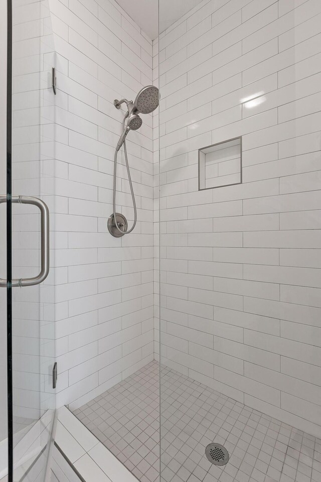 bathroom featuring a shower with door