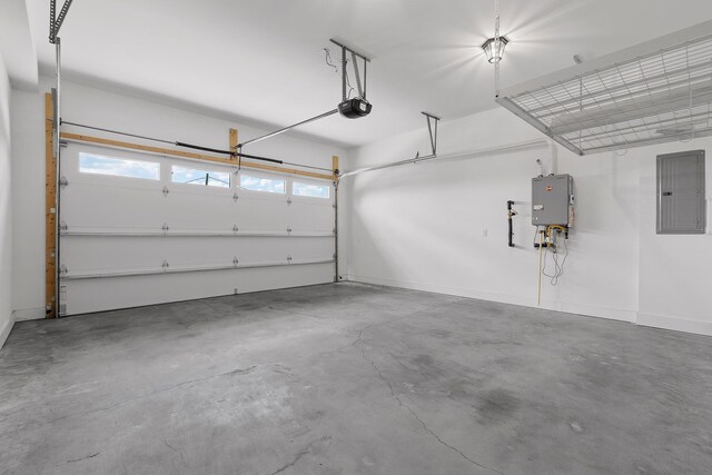 garage with a garage door opener, electric panel, and tankless water heater