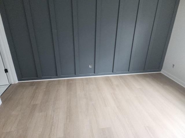 spare room with light hardwood / wood-style flooring