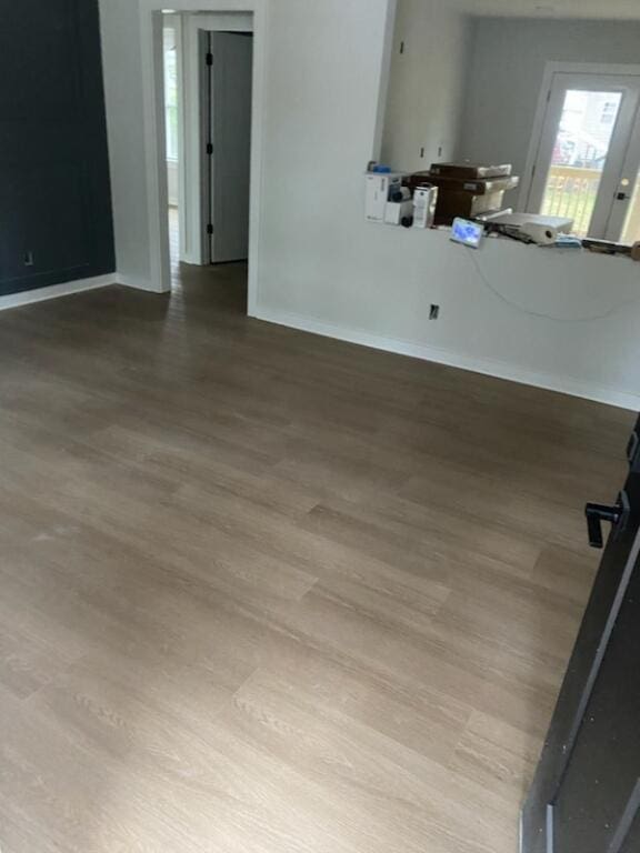 unfurnished living room with wood-type flooring