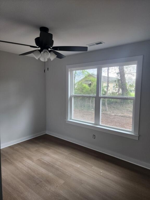 empty room featuring ceiling fan and wood-type flooring