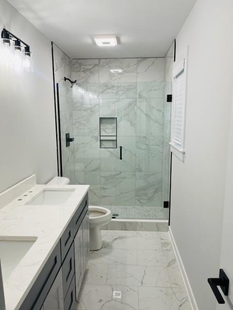 bathroom with vanity, toilet, and an enclosed shower