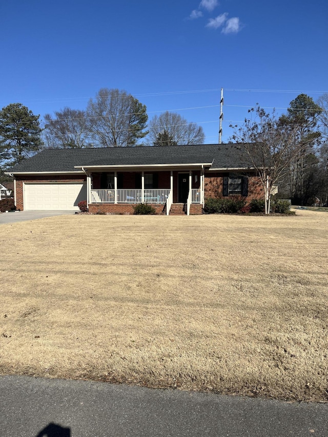 ranch-style house with a porch and a garage