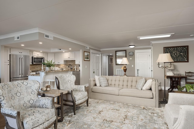 living room featuring crown molding and sink