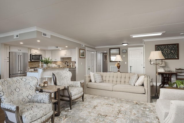 living room with visible vents, recessed lighting, and ornamental molding
