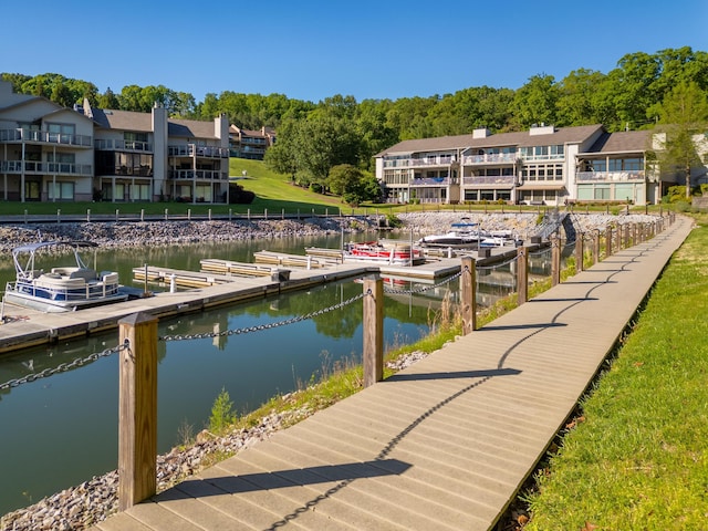 view of dock with a residential view and a water view