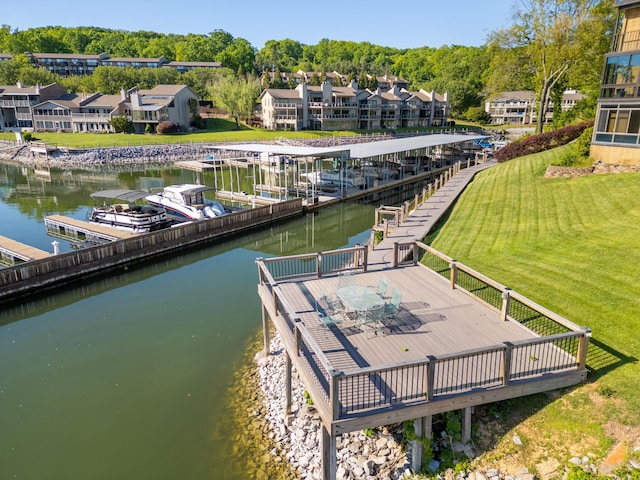 dock area with a residential view, a water view, and a yard