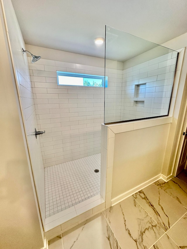 bathroom featuring a tile shower