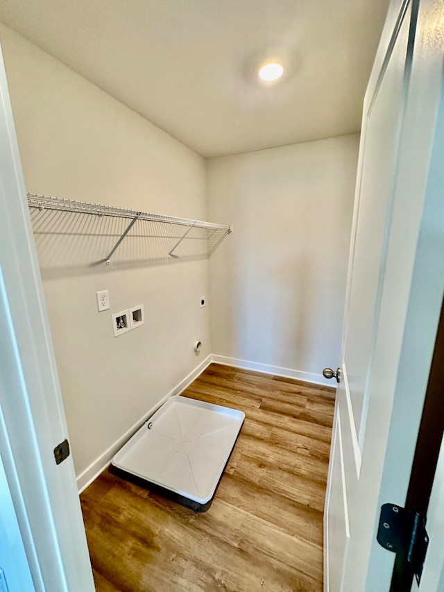 washroom with electric dryer hookup, hardwood / wood-style flooring, and washer hookup