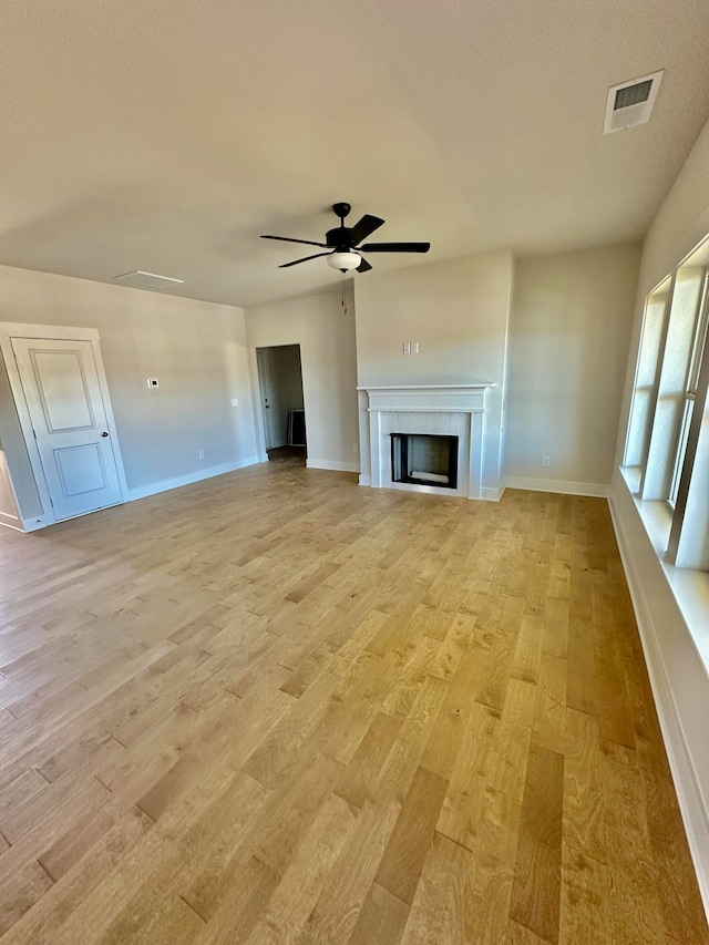 unfurnished living room with light hardwood / wood-style flooring and ceiling fan