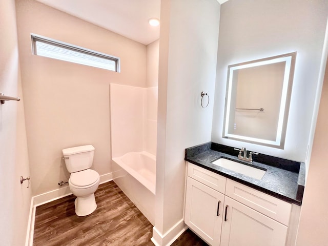 full bathroom with vanity, toilet, hardwood / wood-style floors, and bathtub / shower combination