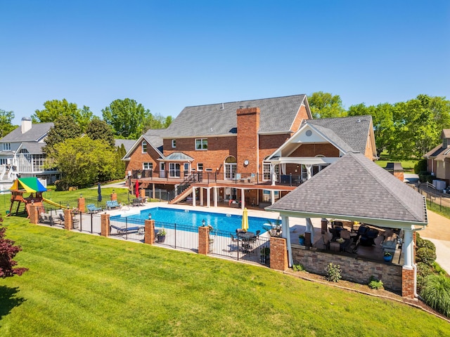 view of swimming pool featuring a lawn and a patio area