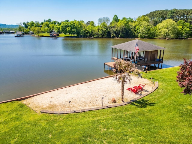 view of dock featuring a water view and a yard