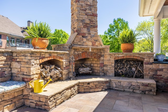 view of patio / terrace with an outdoor stone fireplace