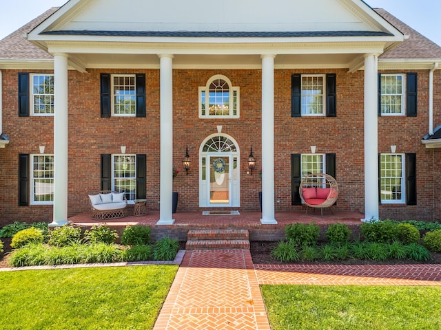 greek revival house featuring a porch