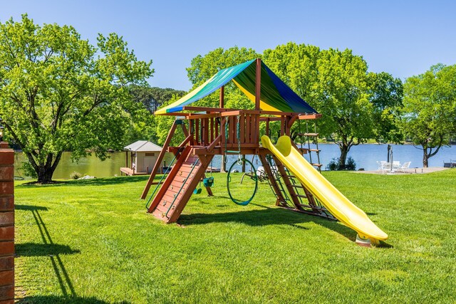 view of jungle gym featuring a water view and a yard