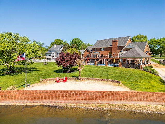 exterior space featuring a water view and a yard