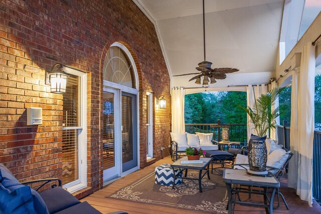 wooden terrace with ceiling fan and an outdoor hangout area