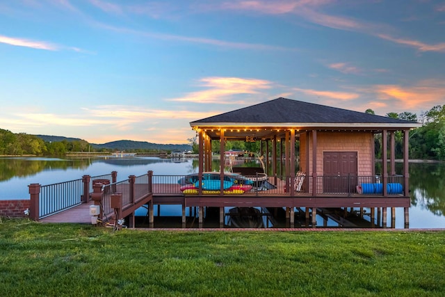 dock area featuring a yard and a deck with water view