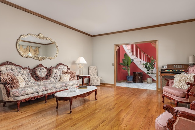 living room featuring ornamental molding and light hardwood / wood-style flooring