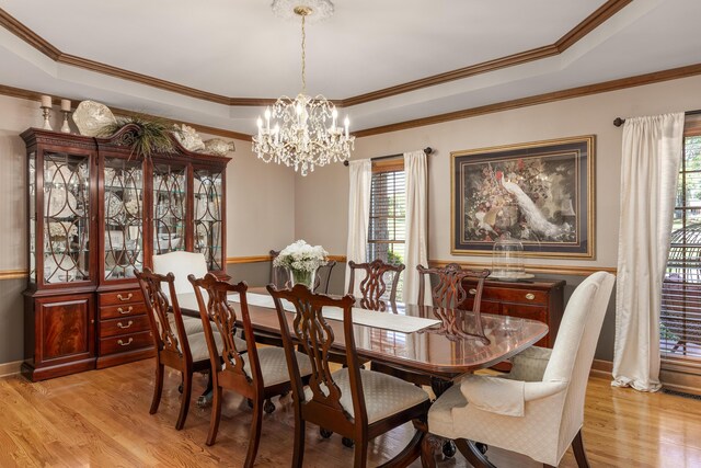 dining area with plenty of natural light, crown molding, and light hardwood / wood-style flooring