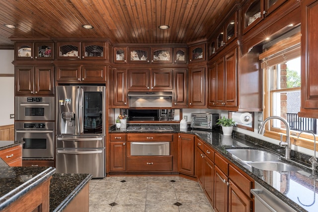 kitchen with stainless steel appliances, dark stone countertops, sink, and wooden ceiling