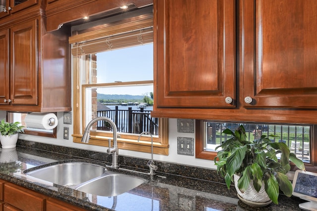 kitchen with dark stone counters and sink