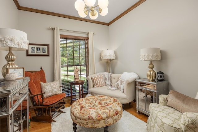 sitting room featuring ornamental molding, a chandelier, and light hardwood / wood-style flooring