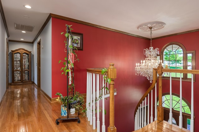 interior space with crown molding, light hardwood / wood-style flooring, and a notable chandelier