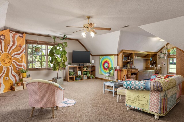 carpeted living room with vaulted ceiling, a textured ceiling, and ceiling fan