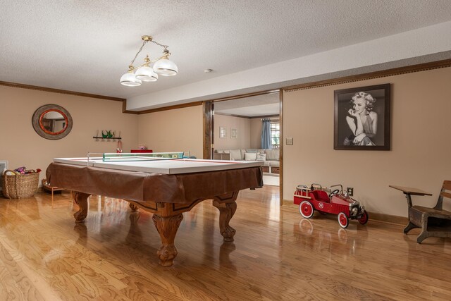 recreation room with a textured ceiling, light hardwood / wood-style flooring, and pool table