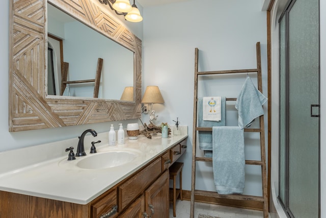 bathroom with vanity, an enclosed shower, and tile patterned floors