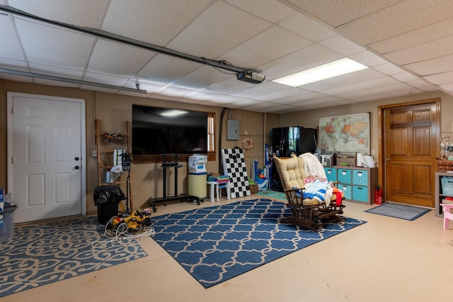 living area with a drop ceiling