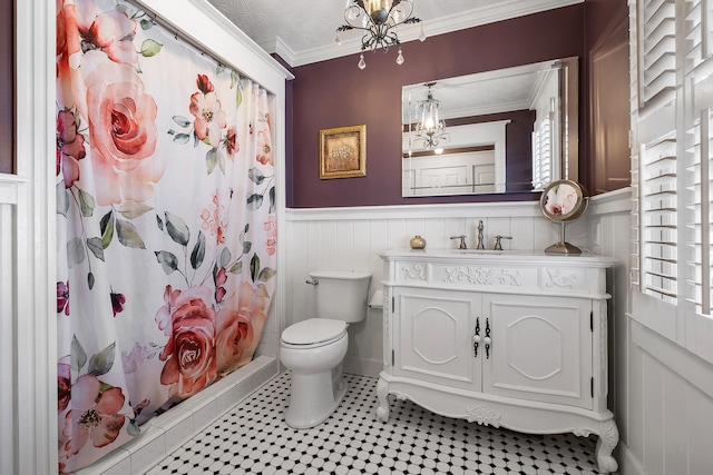 bathroom with crown molding, vanity, toilet, and a shower with shower curtain