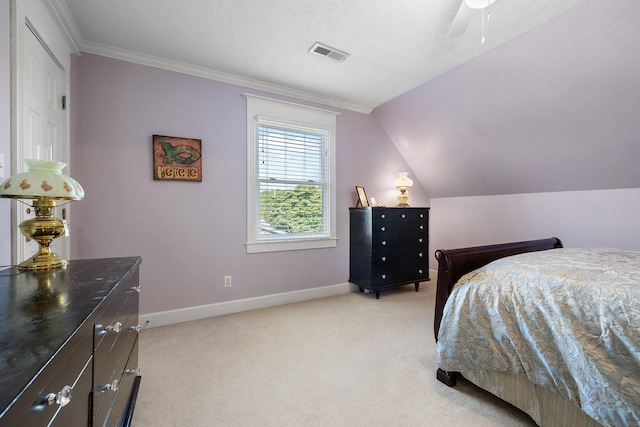 carpeted bedroom with a textured ceiling, ceiling fan, ornamental molding, and vaulted ceiling