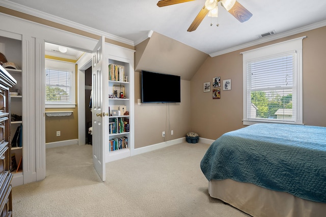 carpeted bedroom with crown molding, vaulted ceiling, and ceiling fan