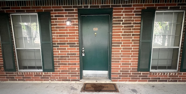 property entrance with brick siding