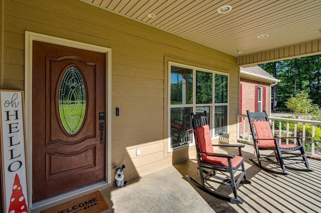 view of exterior entry featuring a porch