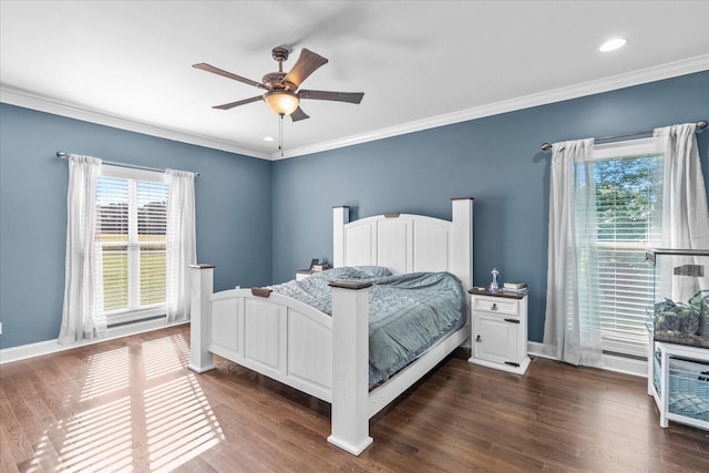 bedroom featuring crown molding, dark wood-type flooring, and ceiling fan