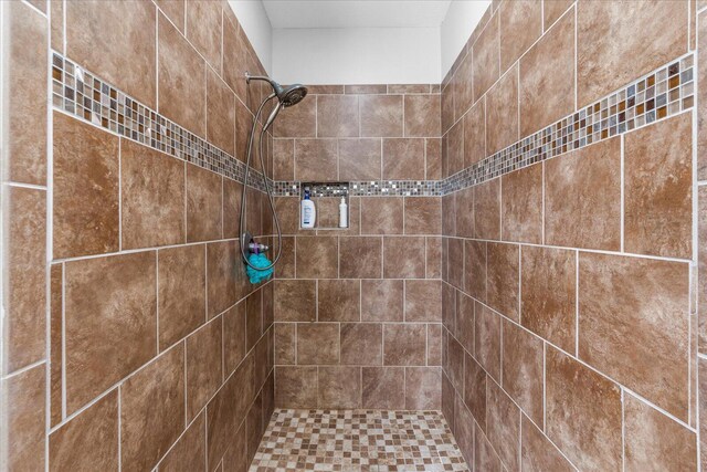 bathroom with a tile shower