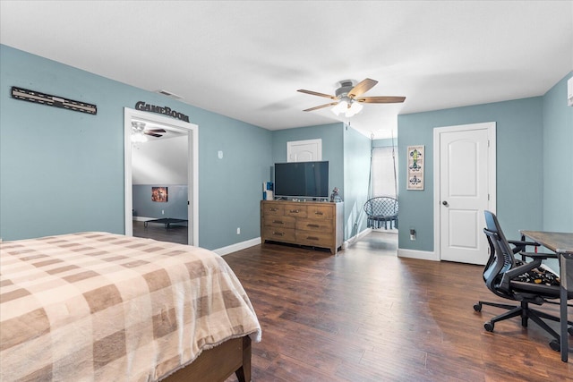 bedroom with dark hardwood / wood-style flooring and ceiling fan