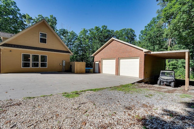 view of side of property featuring a garage and a carport