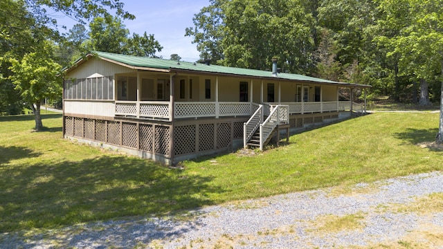 view of front of home featuring a front yard and metal roof