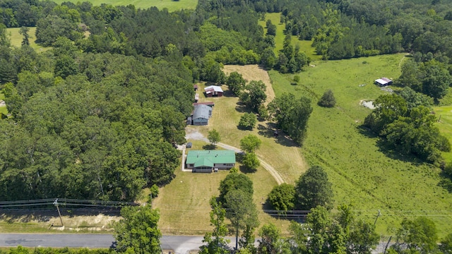 birds eye view of property featuring a forest view