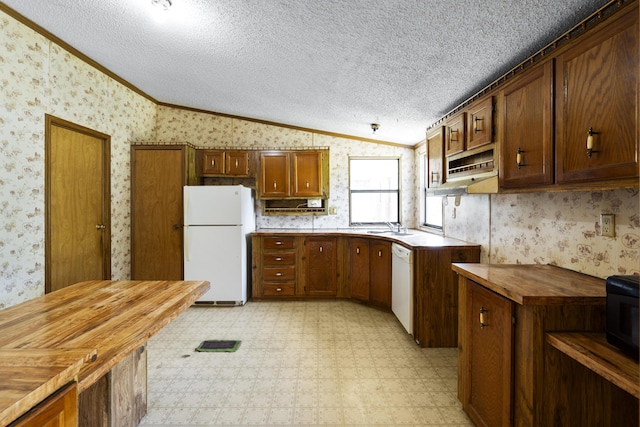 kitchen with vaulted ceiling, wallpapered walls, white appliances, wooden counters, and light floors