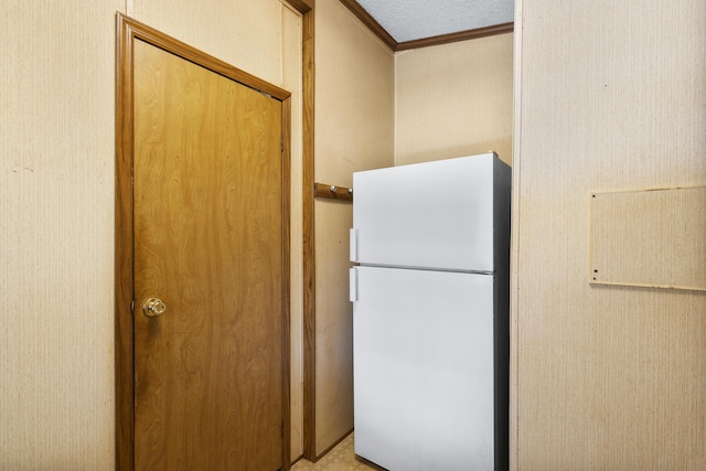 interior space with freestanding refrigerator and ornamental molding