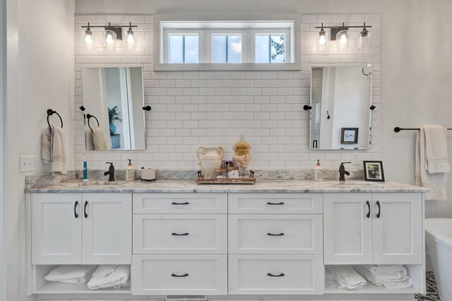 bathroom with vanity, a bath, and backsplash